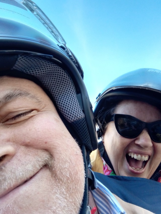 man and woman on scooter smiling