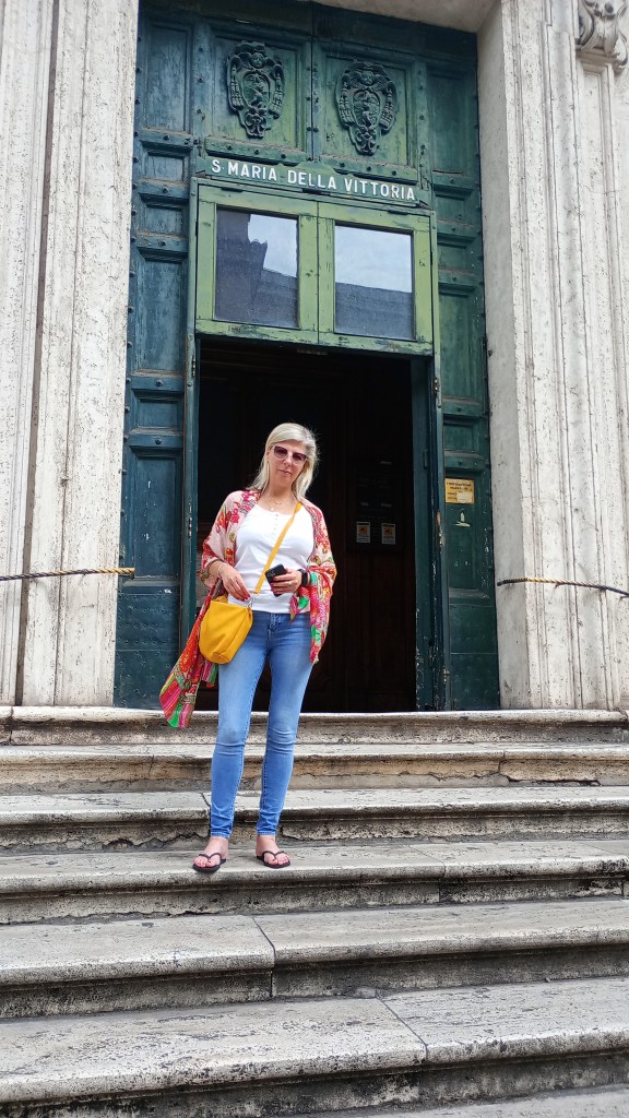 Woman on the steps of the church Santa Maria Della Vittoria, Rome 