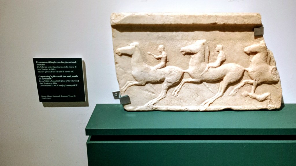 fragment of a frieze with men riding horses