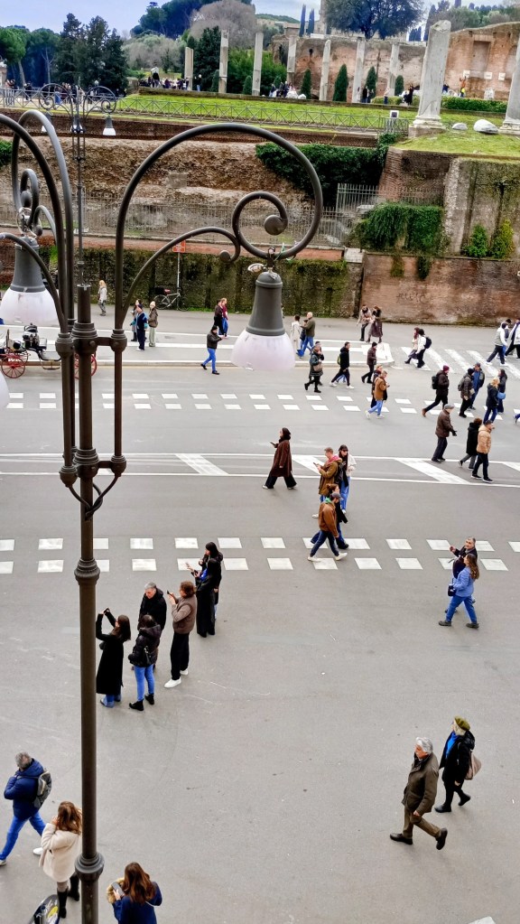 via dei Fori Imperiali with some people walking and some people on foot scooters