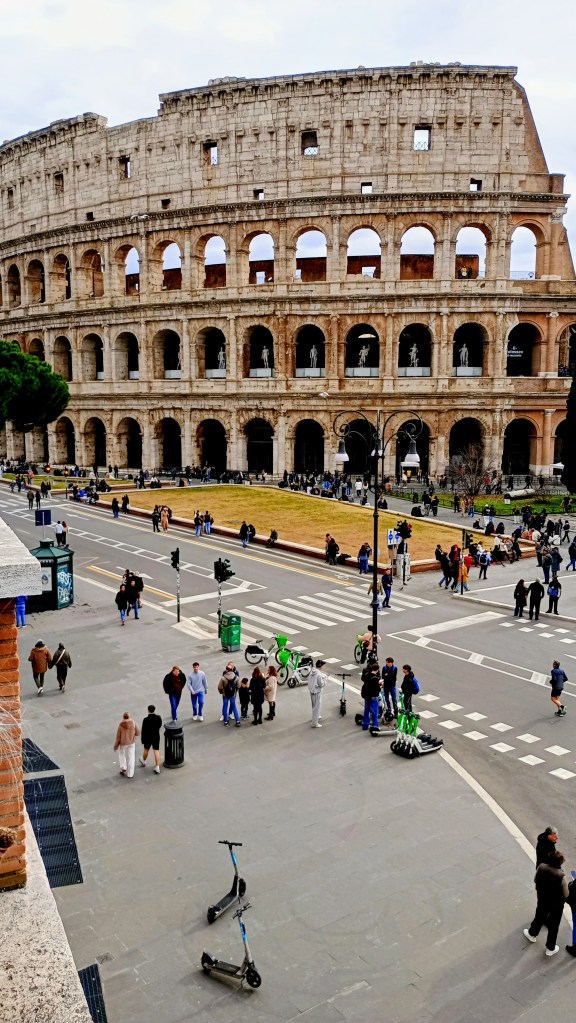 a view of via dei fori imperiali and the colosseum