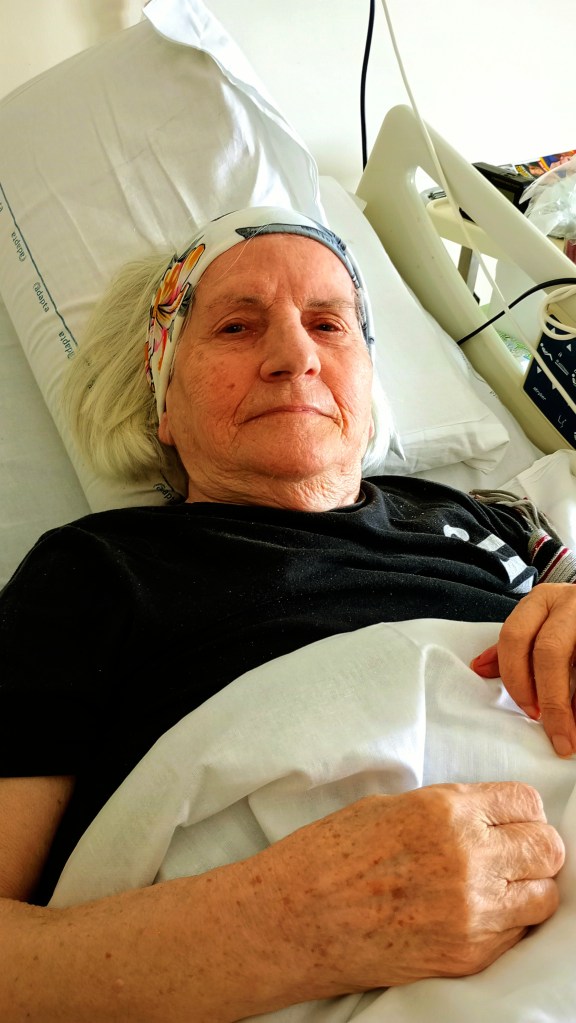 Photo of an elderly lady lying in a hospital bed