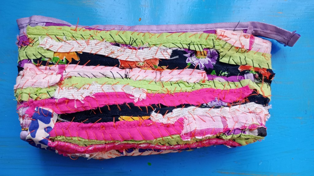photo of a pencil case that's being mended with fabric scraps