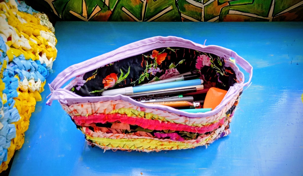 photo of a pencil case that's being mended with fabric scraps