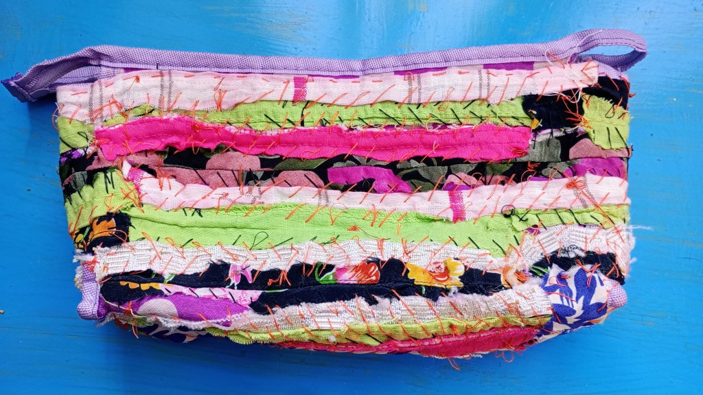 photo of a pencil case that's being mended with fabric scraps