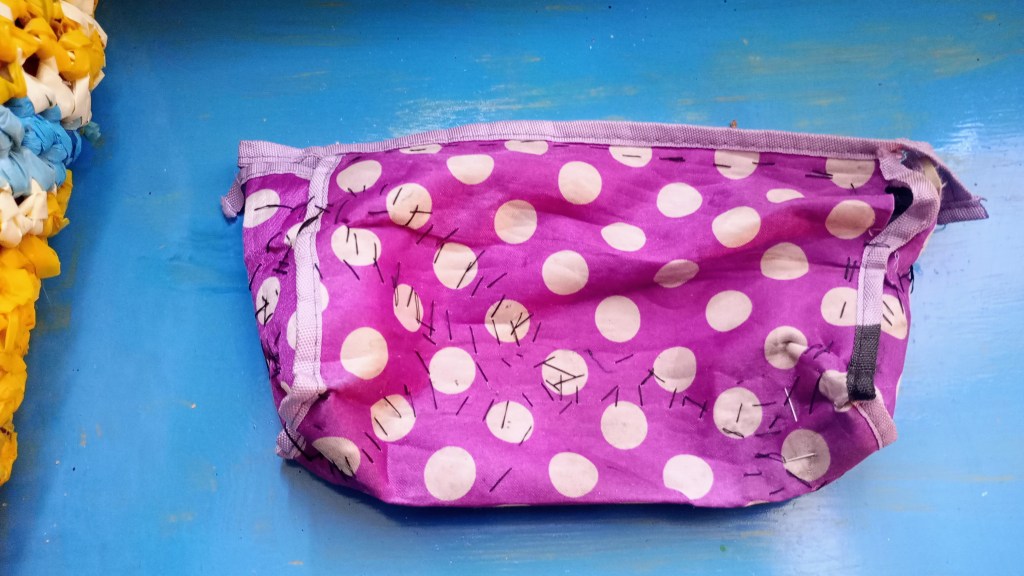 photo of a pencil case that's being mended with fabric scraps