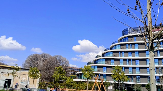 photo of a building, a tree, and a cloud in the sky