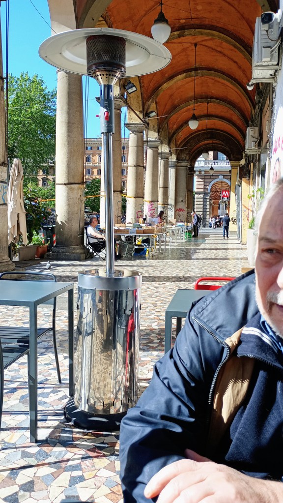 photo of Piazza Vittorio, man under the portico waiting for a coffee