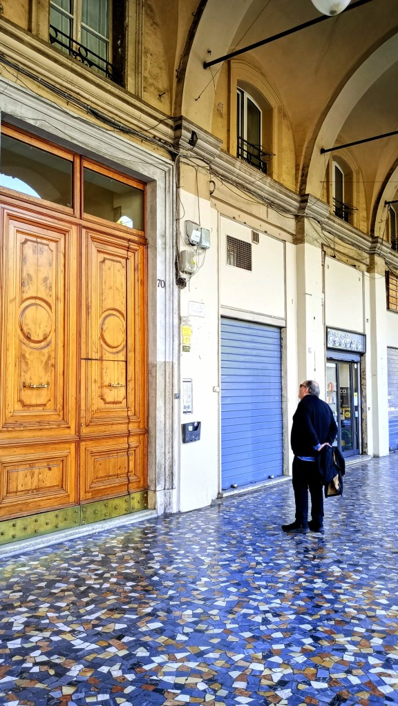 photo of Piazza Vittorio, under the portico in front of a big door